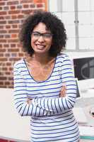 Smiling businesswoman with arms crossed in office