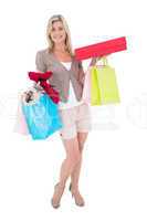 Happy blonde with shopping bags and gifts