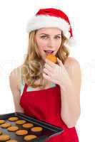 Festive blonde eating hot cookies