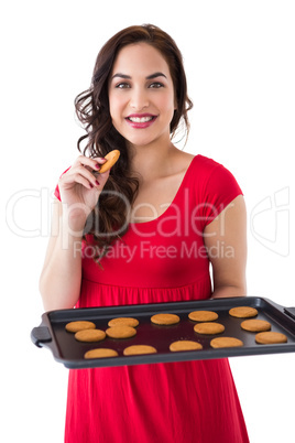 Smiling blonde eating hot cookies