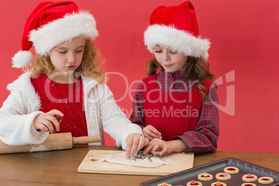 Festive little girls making christmas cookies