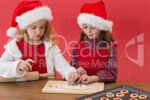 Festive little girls making christmas cookies