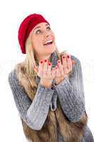 Blonde in winter clothes with hands out