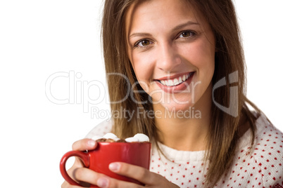 Cheerful cute brunette sitting on couch holding mug