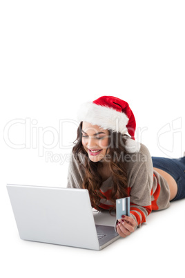 Smiling brunette shopping online with laptop