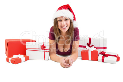 Festive brunette lying on the floor with many gifts