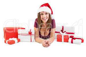 Festive brunette lying on the floor with many gifts