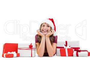 Festive brunette lying on the floor with gifts