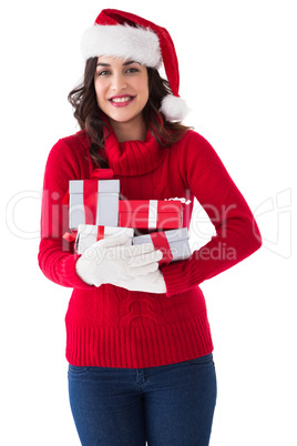 Festive brunette in winter clothes holding gifts