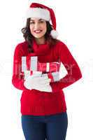 Festive brunette in winter clothes holding gifts