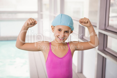 Cute little girl flexing her arms