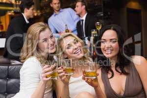 Pretty friends having a drink together