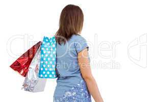 Rear view of young woman with shopping bags