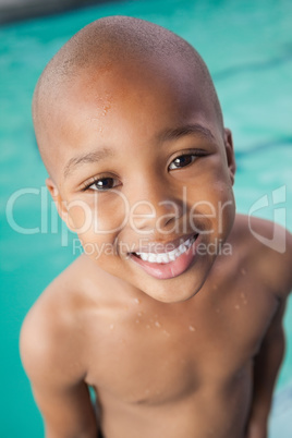 Cute little boy smiling at the pool