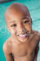 Cute little boy smiling at the pool