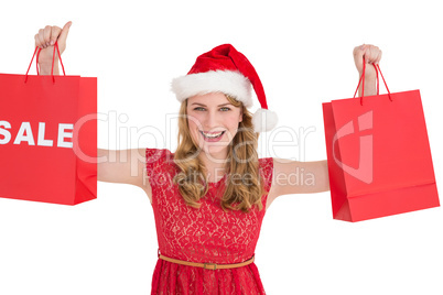 Festive blonde holding sale shopping bags