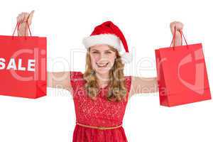 Festive blonde holding sale shopping bags