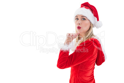 Festive blonde blowing a kiss