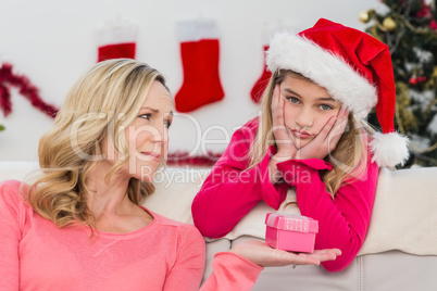 Festive mother and daughter with gift