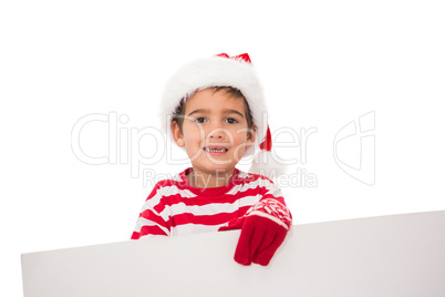 Festive little boy showing a card