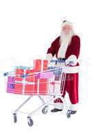 Santa pushes a shopping cart with presents