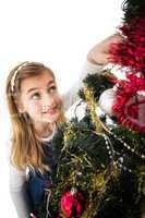 Festive little girl decorating christmas tree