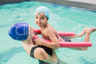 Happy mother and son in the swimming pool