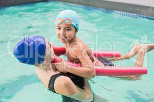 Happy mother and son in the swimming pool