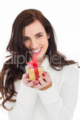 Portrait of a brunette holding gild gift