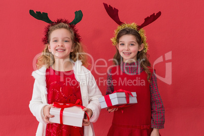 Festive little girls holding gifts