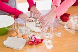 Festive mother and daughter making christmas cookies