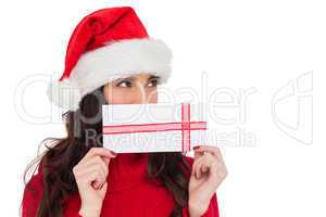 Festive brunette holding a gift