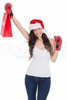 Festive brunette in boxing gloves with shopping bag