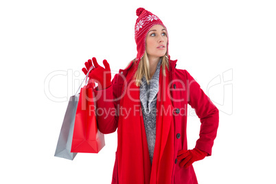 Blonde in winter clothes holding shopping bags