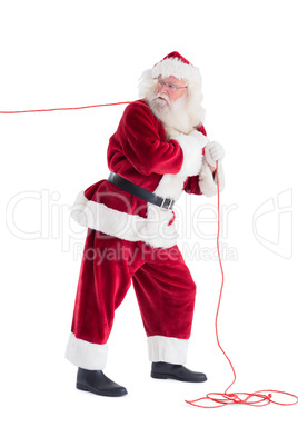 Santa pulls something with a rope
