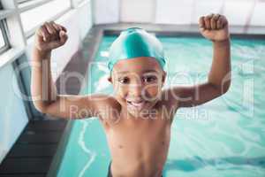 Cute little boy cheering at the pool