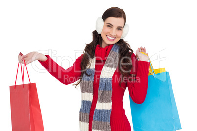 Brunette in winter clothes holding shopping bags