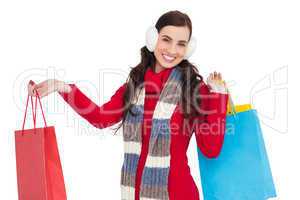 Brunette in winter clothes holding shopping bags