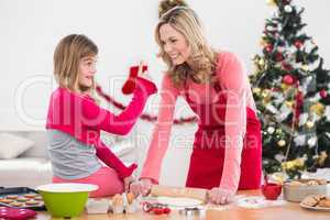 Festive mother and daughter making christmas cookies