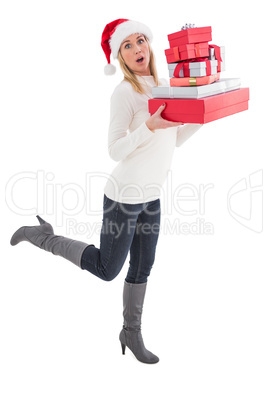 Festive blonde holding pile of gifts