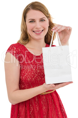 Pretty blonde in red dress holding a shopping bag