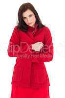 Pretty brunette in red coat posing