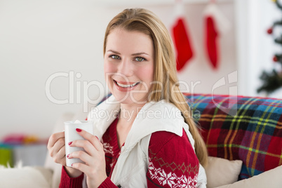 Portrait of woman having coffee on couch