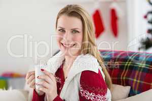 Portrait of woman having coffee on couch