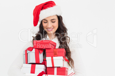 Festive brunette holding pile of gifts