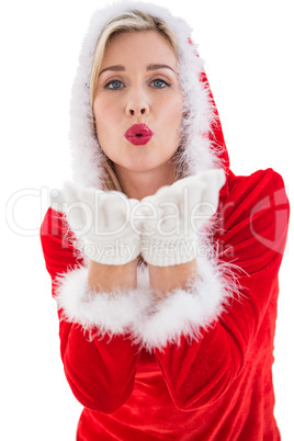 Festive blonde blowing a kiss