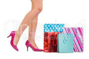 Womans legs in high heels with shopping bags