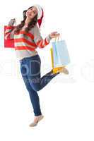 Festive brunette posing with shopping bags
