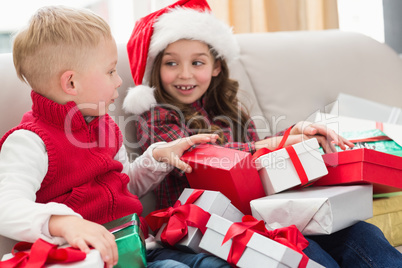 Festive siblings surrounded by gifts