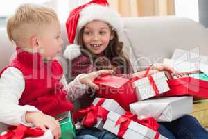 Festive siblings surrounded by gifts